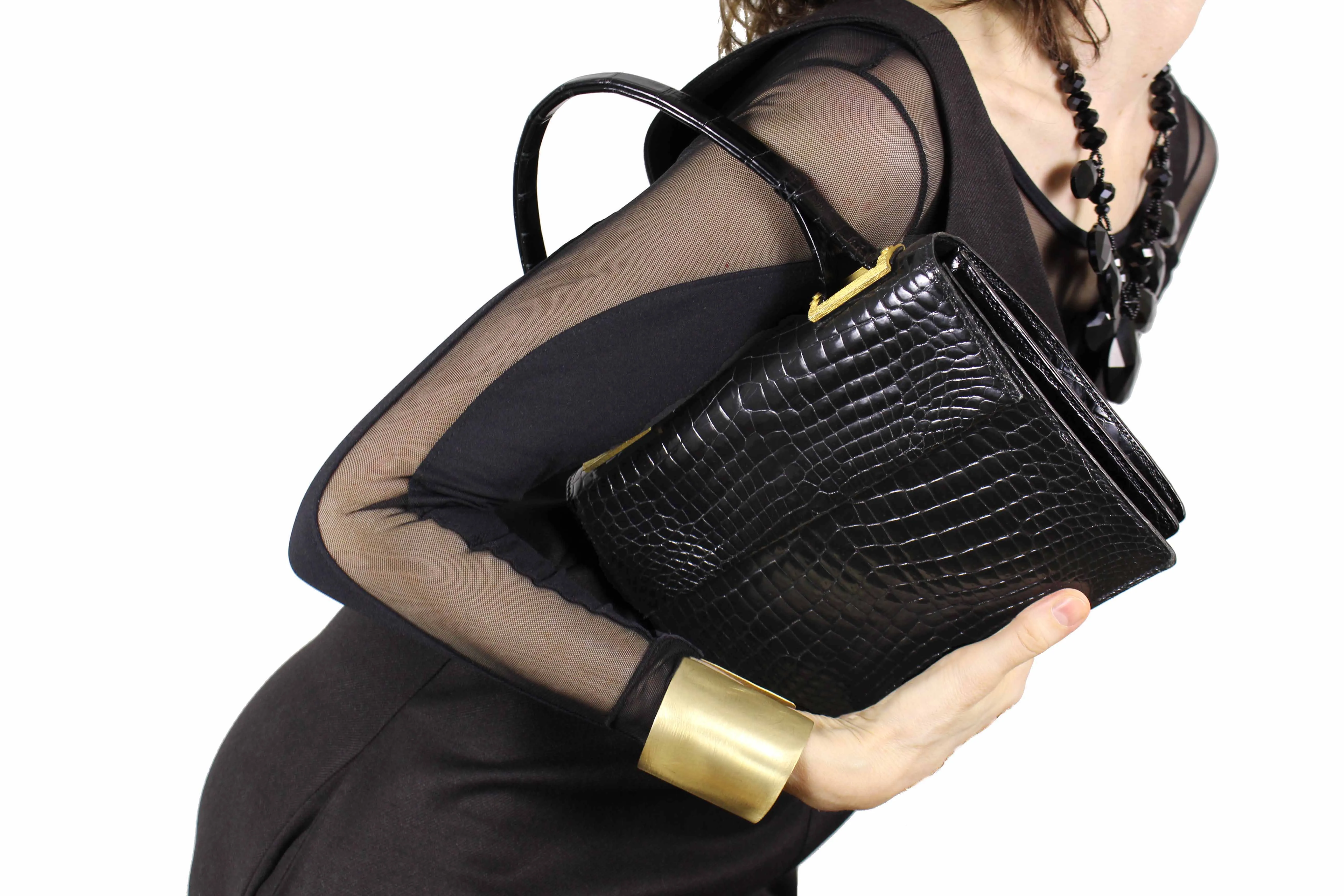 Jet black baby crocodile handbag with decorative handle